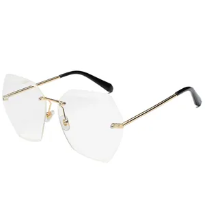 Gafas de sol poligonal sin montura de mujer con marco dorado y lentes elegantes de moda.