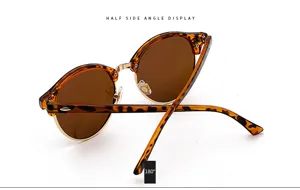 Detailed side view of half frame tortoiseshell sunglasses with brown lenses and metal bridge.