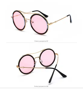 Gafas de sol redondas de metal vintage con lentes rosas y diseño de doble puente.