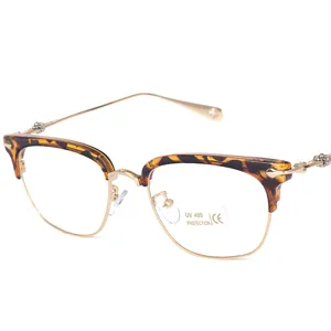 Retro half-frame eyeglasses with tortoiseshell browline and delicate temple carvings.
