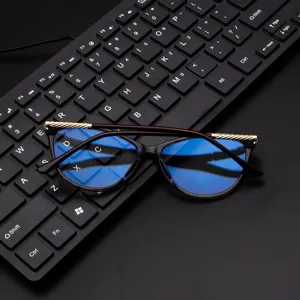 Women cat eye blue light blocking glasses with stylish gold metal temples and clear frame design.