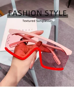 Detailansicht modischer, oversized Farbverlauf Sonnenbrille mit pinken und roten Rahmen.