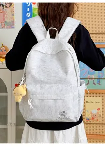 Detailed view of casual nylon backpack with cute pendant, grey heathered fabric and embroidery.