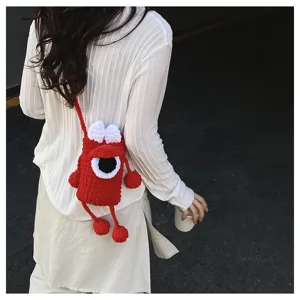 Handmade knitted cute monster crossbody phone bag for women, stylish red shoulder bag.