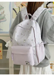 Cute Japanese style canvas backpack detail showing dog print, stripes, and lovely lace pendant.