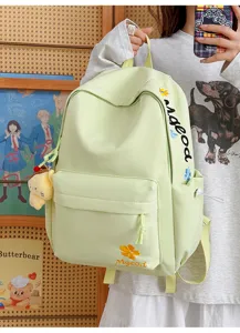 Light green nylon school backpack for students, large capacity with embroidery details and cute charm.