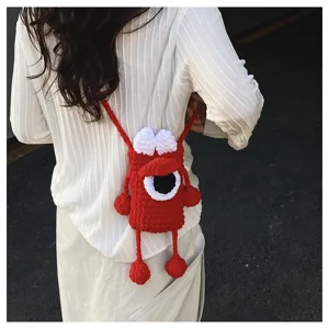 Handmade red crochet crossbody phone bag with cute single-eye monster design for women.