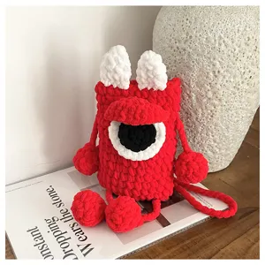 Detailed shot of cute handmade crochet red monster phone bag with single eye and texture.