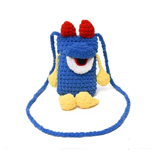 Handmade knit monster phone bag detail, cute big eye cross body bag with strap.