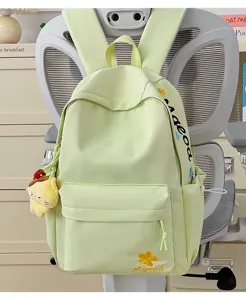 Detailed view of the casual light green nylon backpack with cute embroidery and pendant.
