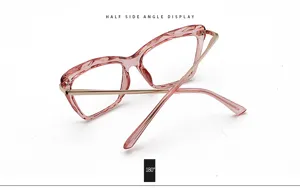 Detailed view of trendy butterfly optical glasses frame, pink resin front with metal temples.