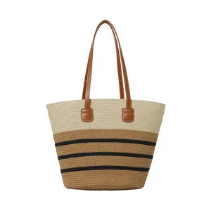 Detail view of the stylish straw beach tote bag featuring color-block design and comfortable straps.