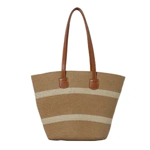 Detailed view of the straw woven stripe tote bag, chic contrast design for summer beach.