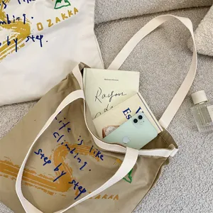 Casual canvas tote bag with stylish letter print, large capacity for daily commute.