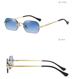 Detailed view of fashionable polygonal rimless sunglasses with gradient blue lenses and carved temples.