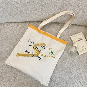 Canvas tote bag with letter print, casual shoulder bag for daily use, large capacity design.