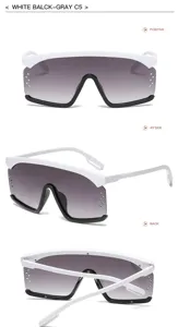 Detailansicht der übergroßen Schild-Sonnenbrille mit weißem Rahmen und grauen Verlaufsgläsern.