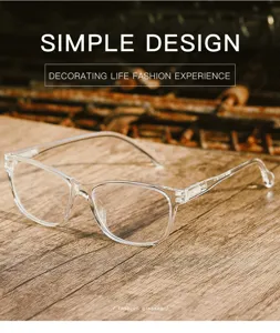 Close-up detail of clear square anti-blue light glasses with spring temple on wooden desk.