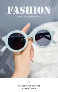 Close-up detail of cream round-framed sunglasses, retro punk style, stylish eyewear design.