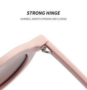 Pink round frame sunglasses detail shot showing durable smooth opening metal hinge design.