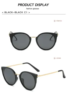 Lunettes de soleil chat noires tendance avec branches en métal doré et verres gris.