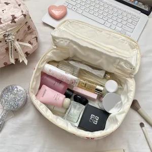 Portable large capacity cosmetic bag with cute bear print, multi-layer travel makeup pouch.