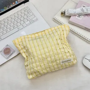Yellow plaid cosmetic bag portable makeup pouch stylish storage bag for daily use and travel.