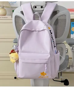 Close-up of a light purple nylon backpack with cute embroidery detail and a plush toy pendant.