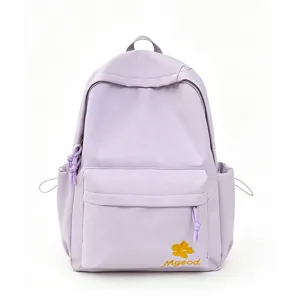 Detailed view of the light purple nylon backpack featuring floral embroidery and front pocket.