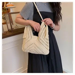 Beige crochet hollow shoulder bag detail, stylish tassel and wooden bead decoration.