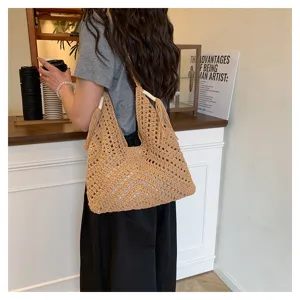 Detailed lifestyle view of a women crochet woven tote bag with fringe, stylish casual style.