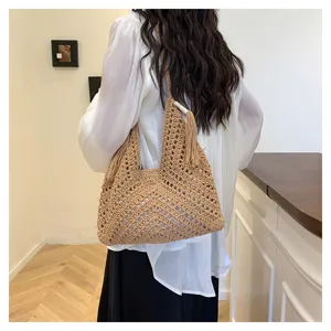 Handmade crochet hollow shoulder bag detail view, casual straw tote for summer beach holiday.