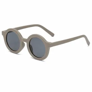 Round frame sunglasses with matte creamy taupe finish and dark lenses for stylish sun protection.