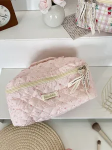 Pink quilted makeup bag, cute rabbit print travel toiletry pouch with convenient handle.