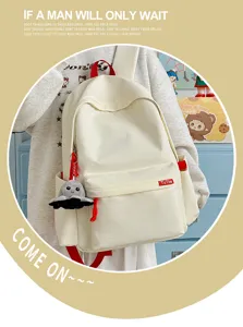 Minimalist solid color student canvas backpack detail with cute octopus pendant and red straps.