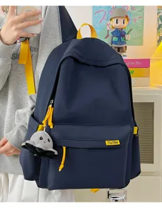 Solid color large capacity school backpack with cute octopus pendant and bright yellow straps.