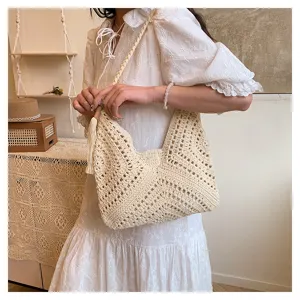 Handmade crochet hollow shoulder bag, chic vintage commuter beach tote for women.
