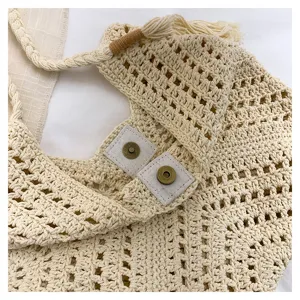 Beige crochet hollow-out tote bag detail, featuring textured knit fabric and sturdy strap.