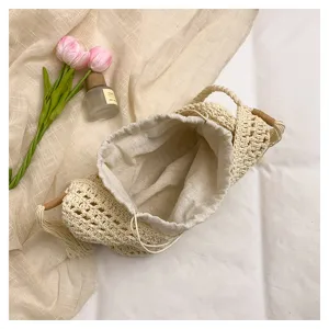 Detail view of the handmade woven hollow beach shoulder bag with inner drawstring lining.