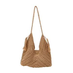 Detailed view of the handmade straw woven hollow hobo shoulder bag with stylish tassels.