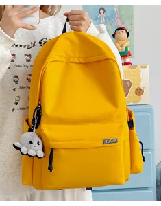Detail view of the stylish yellow casual school backpack, showing spacious compartment and cute details.