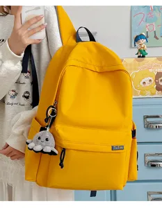 Korean style solid yellow school backpack with large capacity and cute octopus pendant.