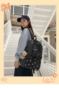 Canvas striped student backpack with star pattern and cute bear pendant detail view.