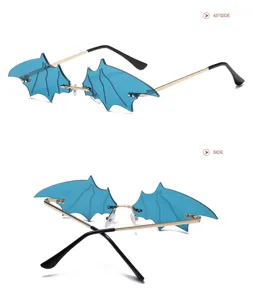 Bat wing rimless sunglasses with blue lenses and gold metal frames for quirky fashion styles.