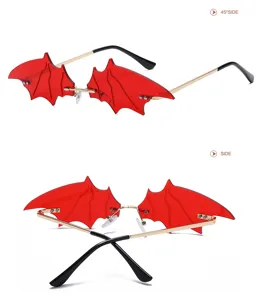 Stylish red bat wing rimless sunglasses with gold metal temples, unique goth eyewear.