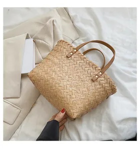 Chic straw woven handbag for women, casual summer shoulder tote bag with brown leather handles.
