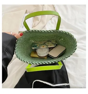 Green woven straw handbag interior detail showing large capacity and daily essentials inside storage.