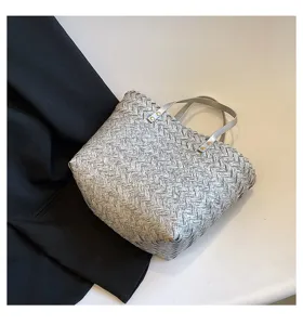 Stylish grey woven tote bag for women, featuring dual top handles and chic casual design.