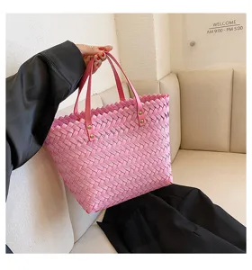Detail view of pink woven tote bag, elegant women shopping bag for daily commuting.