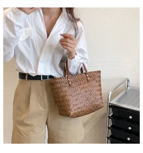 Woven tote handbag for women, chic brown braided shoulder bag with leather handles.